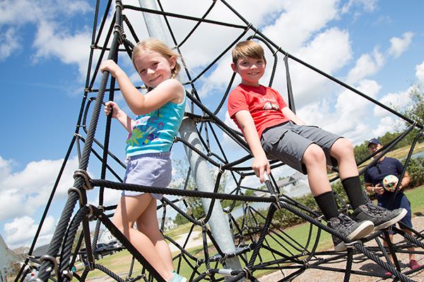 Kids enjoying some outdoor fun at the PARK playground in Riverlights.