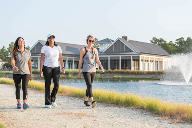 Women walking along lakeside trail in Riverlights