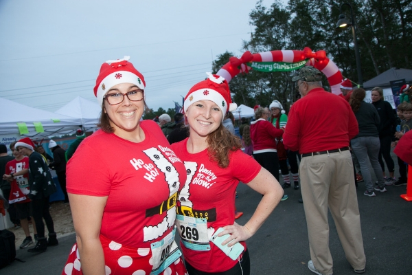 Women with festive shirts and hats at the Half Marathon event