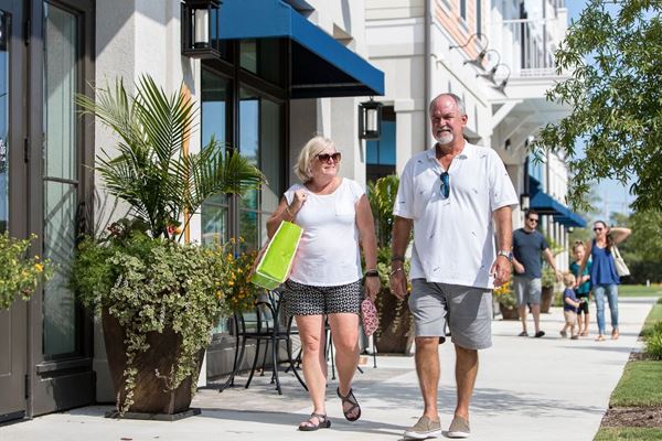 A couple explores the Riverlights Marina Village in Wilmington, NC.