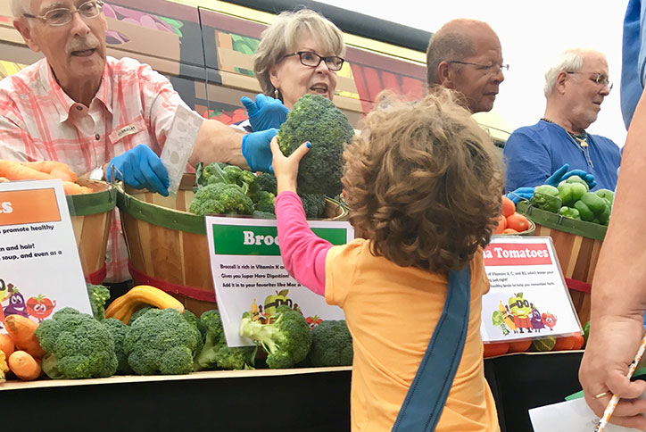 Nourish NC handing our fresh vegetables