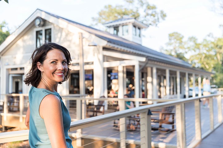 Woman smiling while outside the Smoke on the Water restaurant in Riverlights.