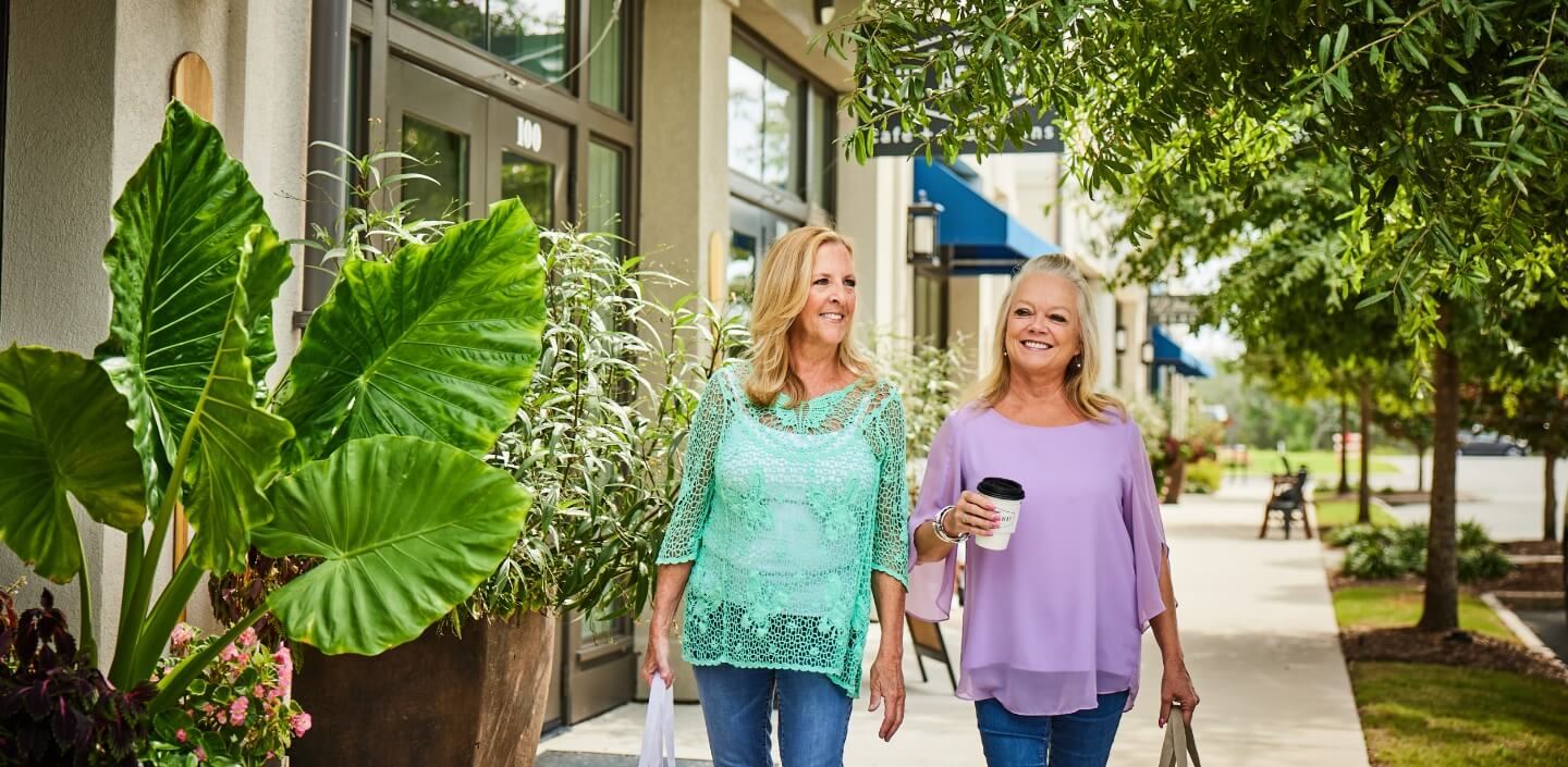 Women walking along Marina Village shopping district in Riverlights