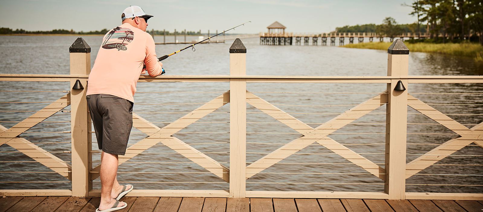 Man fishing from Riverlights pier along the Cape Fear River