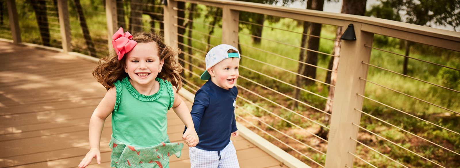 Kids running on boardwalk trail in Riverlights