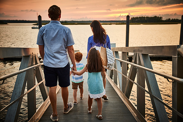 Family on Riverlights pier at sunset
