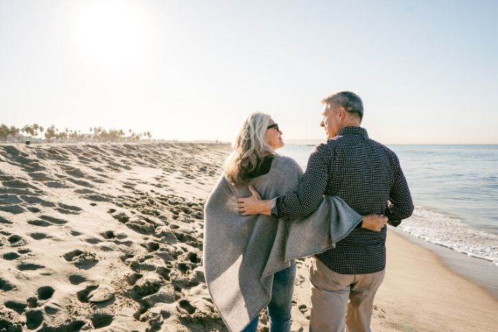 Couple hugging and walking on the beach